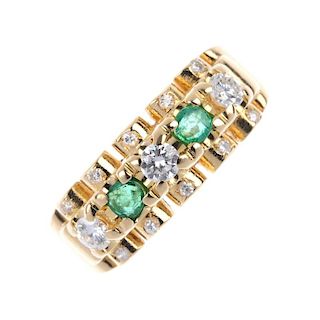 An 18ct gold emerald and diamond dress ring. The alternating brilliant-cut diamond and circular-shap