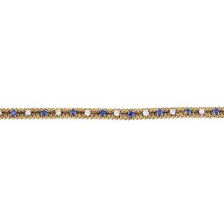 A sapphire and diamond bracelet. The alternating circular-shape sapphire and brilliant-cut diamonds,