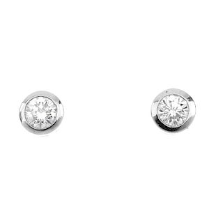 A pair of brilliant-cut diamond collet ear studs. Estimated total diamond weight 0.65ct, H-I colour,