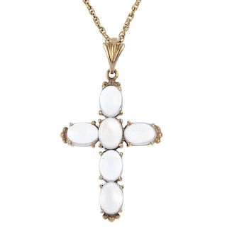 A 9ct gold moonstone cross pendant. The oval moonstone cabochon cross, to the fluted surmount, suspe