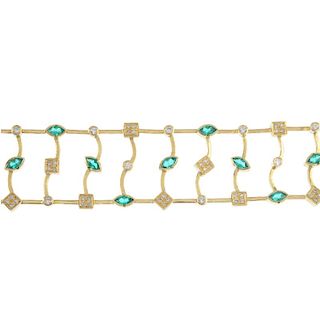 An emerald and diamond bracelet. Of openwork design, the series of curved bars, set with alternating