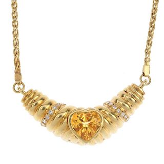 A citrine and diamond necklace.The heart-shape citrine collet, inset to the grooved chevron panel, w