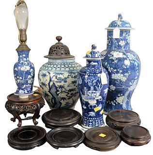 Four Pieces of Chinese Blue and White Porcelain to include two covered vases, a blue and white vase made into table lamp, one vase with wooden cover, 