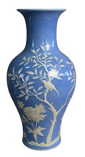 Chinese Blue Glazed Vase with white relief detailing of a bird in a tree, height 15 inches.