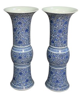 Pair of Chinese Blue and White Beaker Form Vases having vine and floral motif, marked with six characters to the underside, height 20 3/4 inches.