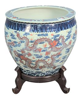 Large Chinese Porcelain Dragon Bowl or Planter on Stand having blue and iron red painted dragon, height 24 inches, depth 21 inches.