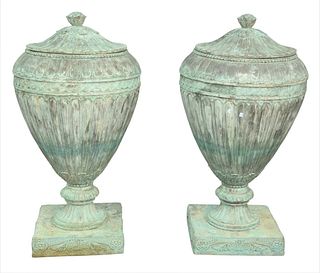 Pair of Bronze Covered Urns having fluted design with fruit finial, set on square base, height 47 inches, diameter 26 inches.
