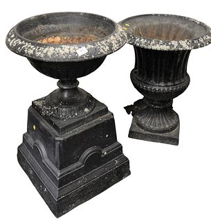 Two Iron Outdoor Urns, two-part, height 32 inches, diameter 21 inches, the other height 27 1/2 inches, diameter 23 inches. Provenance: The Estate of D