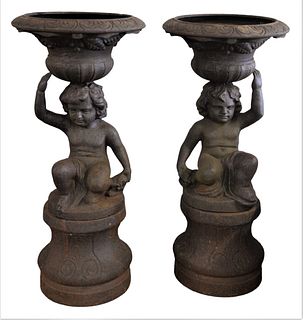 Pair of Cast Iron Figural Two Part Urns or Planters, height 38 inches, diameter 17 1/2 inches.