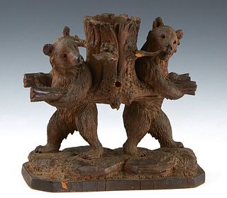 Carved Black Forest Pipe Holder, 19th c., with two standing bears supporting a basket, the outside of the basket with holders for three pipes, H.- 10 