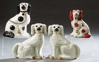 Group of Four English Staffordshire Dogs, 19th c., consisting of a pair of white examples; a single black and white example, and a small brown and whi