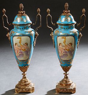 Pair of Sevres Style Brass Ormolu Mounted Porcelain Covered Urns, 20th/21st c., of tapered form, in heavennly blue with gilt and enamel decoration, ar