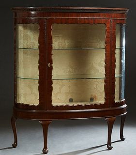 Large Edwardian Queen Anne Style Curved Glass Curio Cabinet, c. 1910, the stepped gadrooned crown over a scalloped curved glass door, flanked by scall