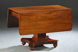 American Classical Carved Mahogany Drop Leaf Dining Table, 19th c., the curved edge top over a skirt with two end drawers, on a tapered square support