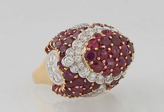 Vintage Lady's 18K Yellow Gold Dinner Ring, the oval domed top mounted with 19 graduated round rubies atop an oval border of round diamonds over curve