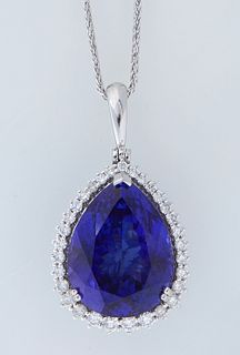 Platinum Pendant, with a 40.84 carat pear shaped tanzanite, atop a conforming border of round diamonds, on a platinum snake chain, total diamond wt.- 