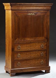 French Louis Philippe Carved Walnut Secretary Abattant, 19th c., the rounded corner top over a cavetto frieze drawer over a fall front desk with an in