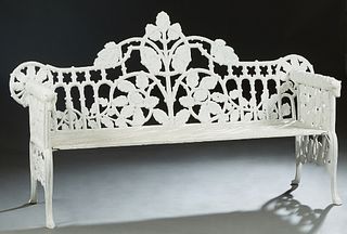 American Aesthetic Style Cast Iron Garden Bench, 20th/21st c., the pierced back with relief leaf and branch decoration, flanked by relief arms with do