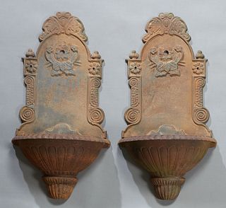 Pair of Cast Iron Wall Fountains, 20th/21st c., the arched backplates over reeded campana form basins, H.- 32 in., W.- 16 in., D.- 10 1/2 in.