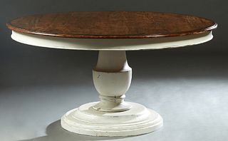 Tuscan Style Carved and Polychromed Mahogany Dining Table, 20th c., the rounded edge circular top over a wide polychromed skirt, on a large polychrome