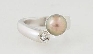 Lady's 18K Yellow and White Gold Dinner Ring, 21st c., by Michele Salvini, the bypass band with an 8mm gold orb on one end and a 15 point round diamon