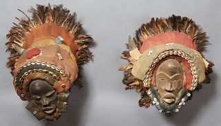 Pair of Kuba African Masks, early 20th c., with cowrie shell and feather decoration, H.- 15 in., W.- 18 in., D.- 10 in. Provenance: Property from Gent
