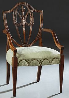 Hepplewhite Style Carved Mahogany Armchair, 19th c., the arched shield back with a pierced vertical splat, to curved square arms and a bowed upholster