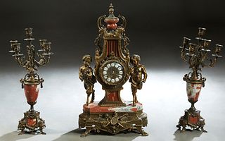 Three Piece Louis XV Style Gilt Brass and Rouge Marble Clock Set, late 20th c., the Franz Hermle time and strike lyre form clock with a marble urn sur