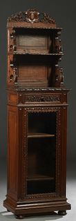French Renaissance Style Carved Oak Display Cabinet, late 19th c., the pierced cartouche carved crest over two graduated open shelves with leaf carved