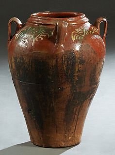 French Provincial Partially Glazed Clay Oil Jar, late 19th c., with four ring handles, the shoulders with polychromed decoration, H.- 22 in., Dia.- 16