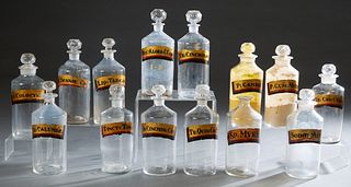 Group of Fourteen Glass Apothecary Bottles, late 19th c., retaining the original painted labels showing original contents, all but one with the origin