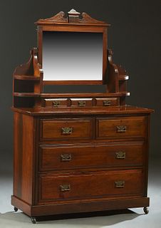 English Carved Mahogany Dresser, c. 1910, with a broken arch crest over a swiveling wide beveled mirror, flanked by two curved shelves on each side, a