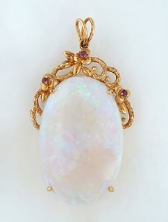 14K Yellow Gold Pendant, with an app. 54 cts. oval cabochon opal topped by a pierced floral loop mount with three small round rubies, beneath a 14K ye