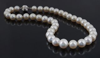 Graduated Strand of Thirty-Nine White Tahitian Cultured Pearls, ranging from 11-13 mm, with a 14K white gold round ball clasp, L.- 16 in., with apprai
