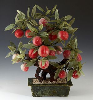 Chinese Carved Jade Peach "Tree," 20th c., in a green hardstone planter, H.- 19 in., W.- 16 in., D.- 8 in.