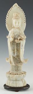 Oriental Carved Jade Figure, 19th c., of Buddha standing on a lotus platform, holding a ruyi scepter, on an oval mahogany plinth, H.- 15 in., W.- 4 in