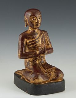 Polychromed and Giltwood Seated Buddha at Prayer, late 19th c., on an integral ebonized base, retaining much of the original gilt, H.- 11 3/4 in., W.-