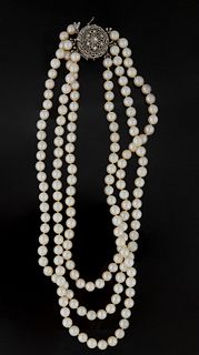 Triple Strand Choker of 6.5-7 mm White Cultured Pearls, with an 18K white gold pierced floriform clasp/enhancer, with a central 10 point round diamond