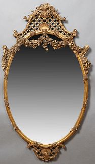Large Impressive Louis XV Style Oval Gilt and Gesso Overmantel Mirror, 19th c., the arched latticed leaf, shell and scroll carved crest over floral ga