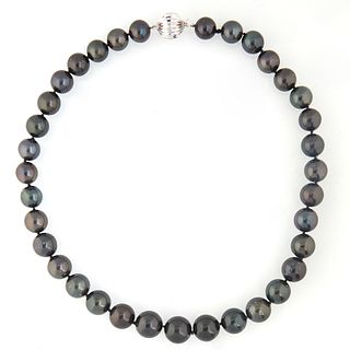 Graduated Strand of Thirty-Five Tahitian Black Cultured Pearls, ranging from 11-14mm., with a 14K white gold ball clasp, L.-,17 in., with appraisal.