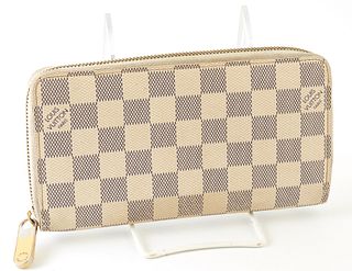 Louis Vuitton Ivory Zippy Wallet, the coated canvas damier azur with a golden brass accent zipper, opening to two card holders, a zip pouch, and three