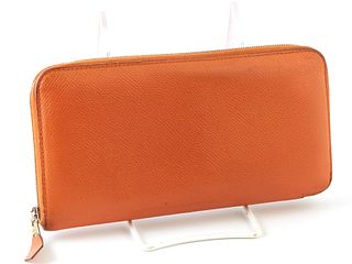 Hermes Orange Azap Wallet, the calf leather epsom leather with a silver accent zipper, opening two card holders, a zip pouch, and four bill compartmen