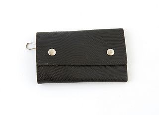 Hermes Black Lizard Skin Four Key Holder, the calf leather with two silver snaps, opening to four silver key holders, H.- 2 9/16 in, W.- 4 9/16 in., D