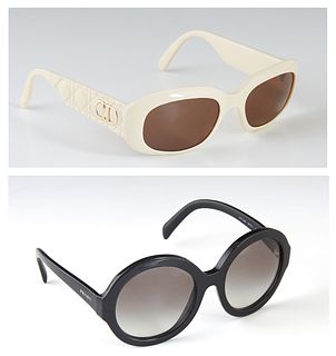 Two Pairs of Vintage Sunglasses, the first a pair of black Prada glasses with a hard case; the second a pair of ivory Christian Dior glasses with a so
