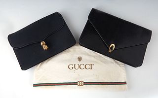 Two Vintage Black Gucci Evening Bags, the first in stamped black leather with gold hardware, the interior of the bag lined in black leather with a sid