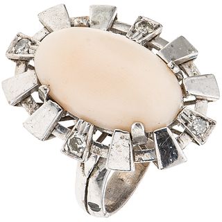 RING WITH CORAL AND DIAMONDS IN PALLADIUM SILVER 1 Cabochon cut pink coral ~6.0 ct and 4 8x8 cut diamonds ~0.12 ct. Size: 6 ½