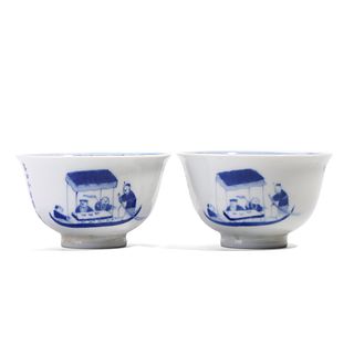 A PAIR OF BLUE AND WHITE FIGURES CUPS