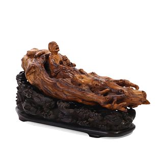 A CARVED WOOD FIGURE OF AN IMMORTAL ON BOAT