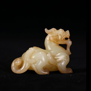 A JADE CARVING OF A MYTHICAL BEAST