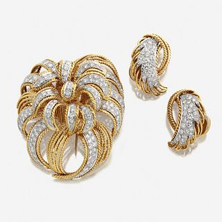 An eighteen karat gold and diamond brooch and matching earrings